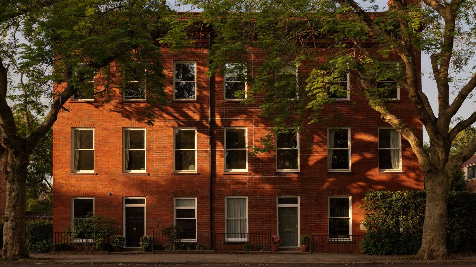 A red-brick terraced street in warm golden-hour light